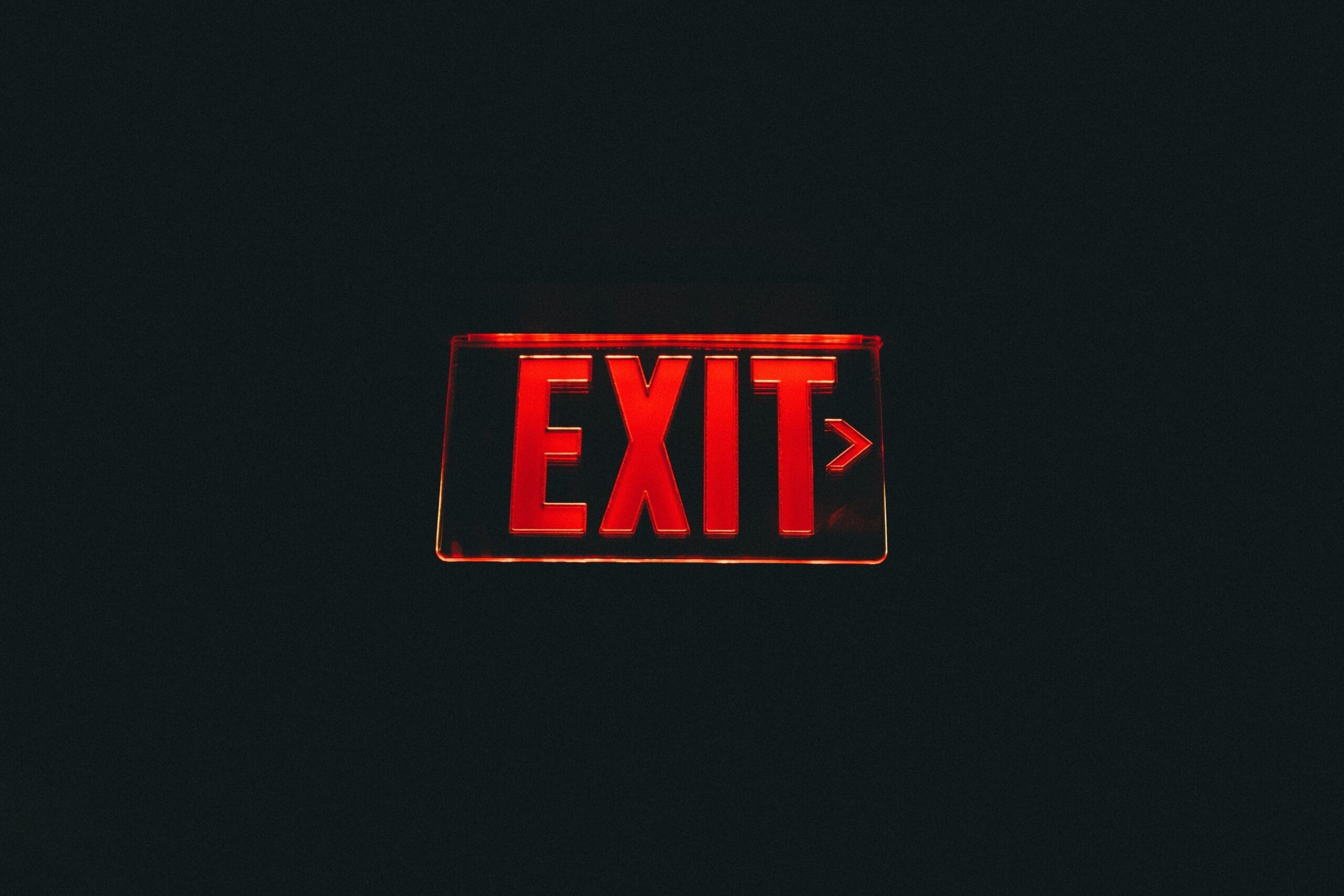 A red exit sign on a wall. 